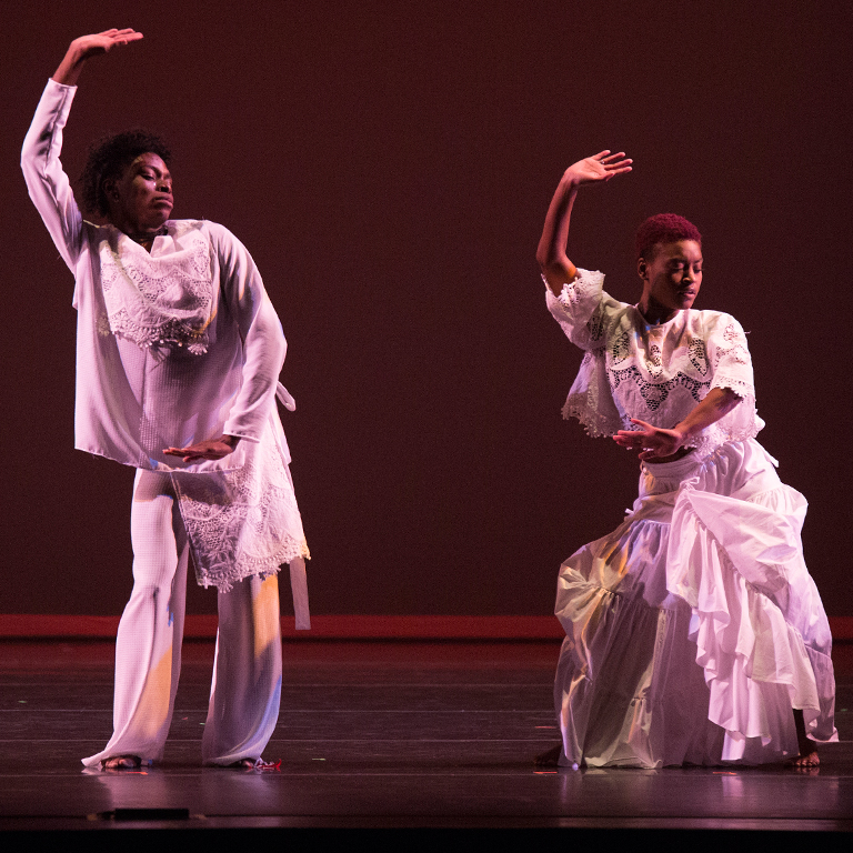 Two performers onstage with the African American Dance Company